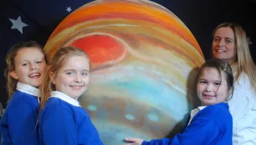 Jo Fox and children from St Peters Primary school in Canterbury with the mighty planet Jupiter